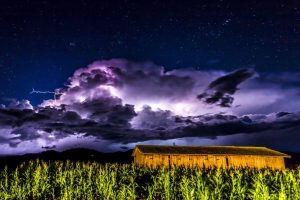 thunderstorm over grass field