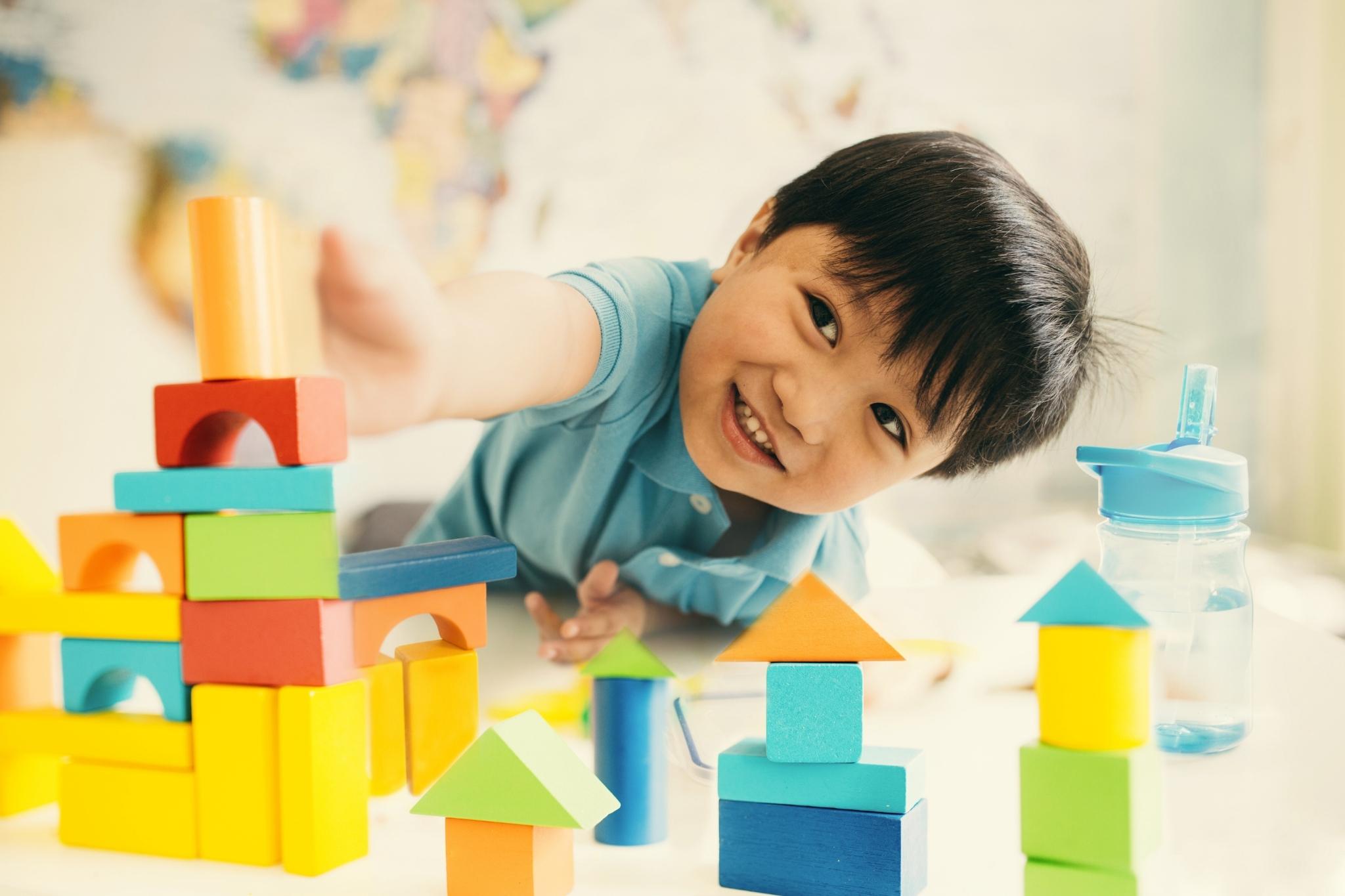young child playing with blocks